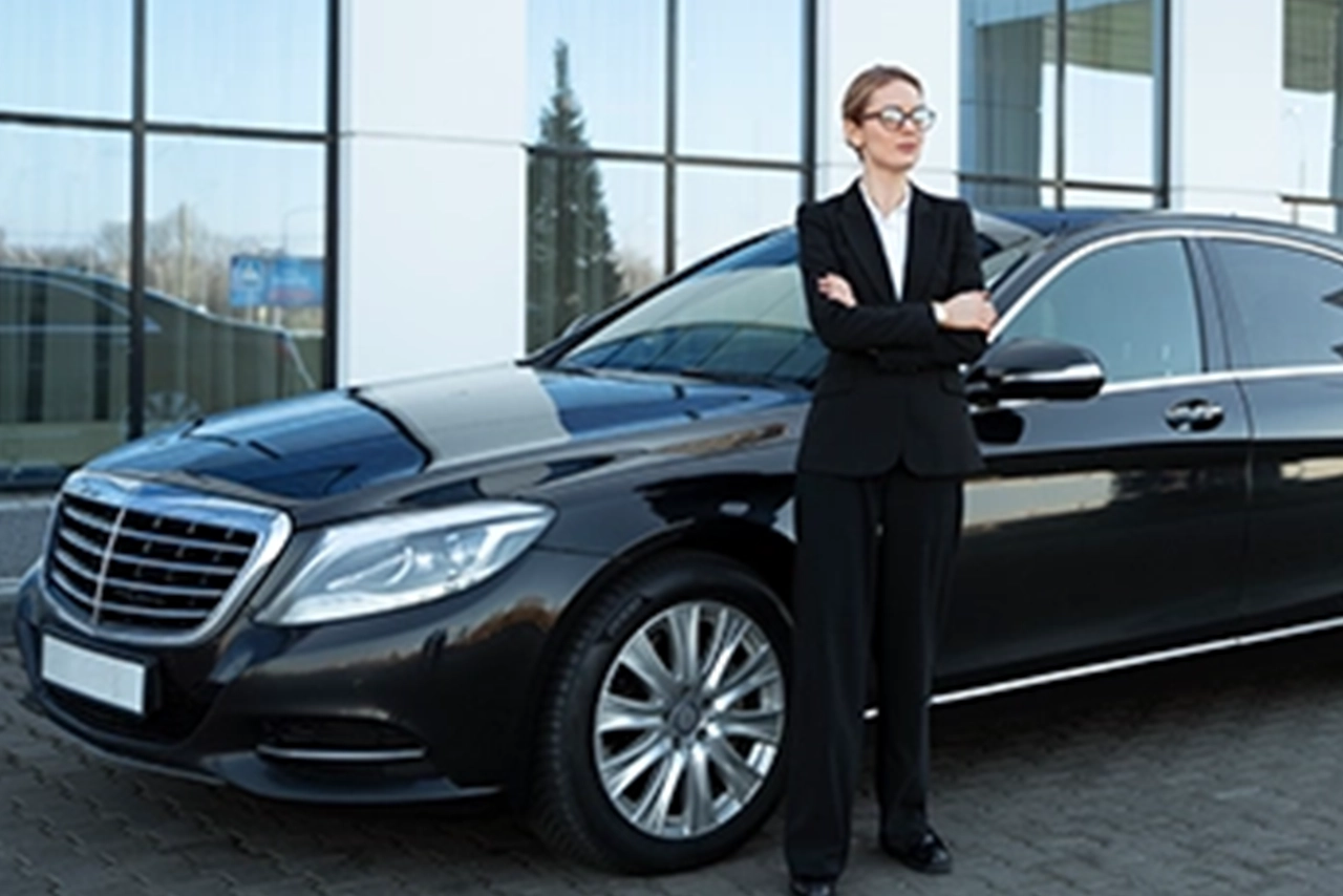 Professional Chauffeur Standing Beside Mercedes-Benz Limo